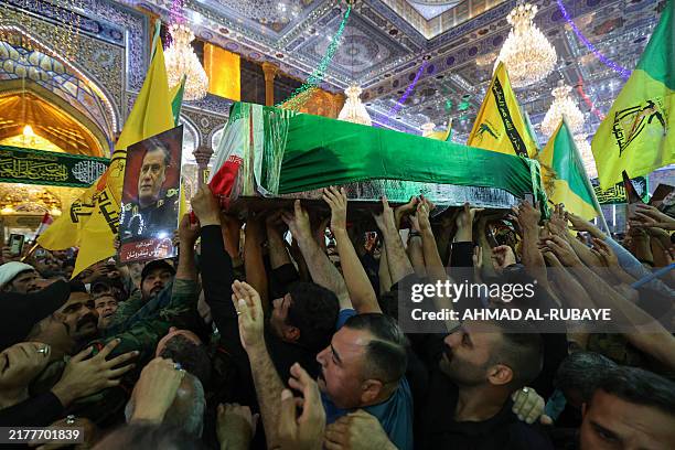 People carry the coffin of Iran's Islamic Revolutionary Guards Corps commander Abbas Nilforoushan during his funeral procession near the Imam Hussein...