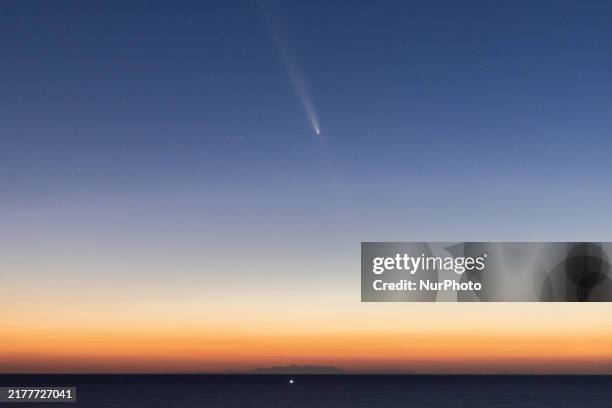 The comet Tsuchinshan-ATLAS is seen over the mountains of the Calabria region from the viewpoint of Torre Uluzzo, near Lecce, Italy, on October 14,...