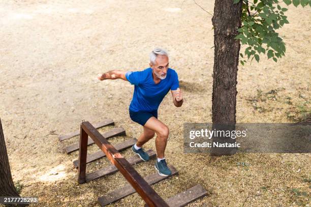 active mature man staying fit outdoors - climbing steps stock pictures, royalty-free photos & images