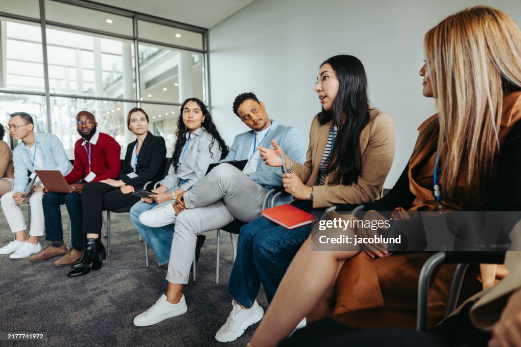 Diverse group in strategy session discussing ideas in modern office setting