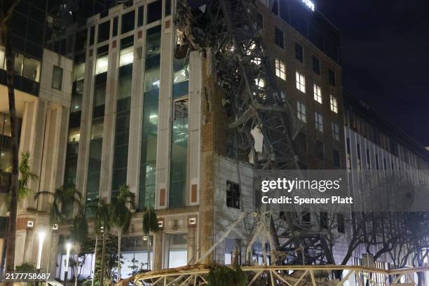 Crane sits on the street after crashing down into the building housing the Tampa Bay Times offices after the arrival of Hurricane Milton on October...