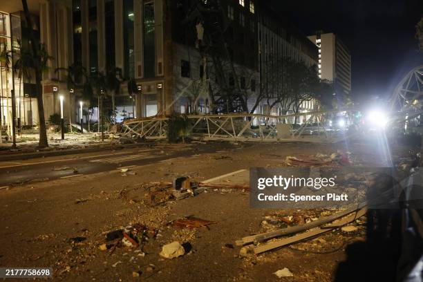 Crane sits on the street after crashing down into the building housing the Tampa Bay Times offices after the arrival of Hurricane Milton on October...