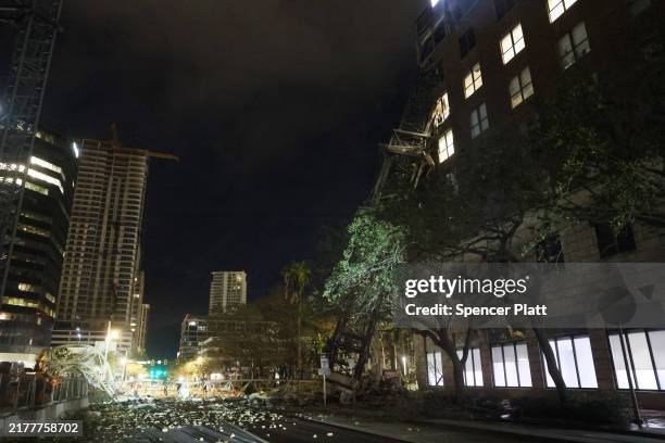 Crane sits on the street after crashing down into the building housing the Tampa Bay Times offices after the arrival of Hurricane Milton on October...