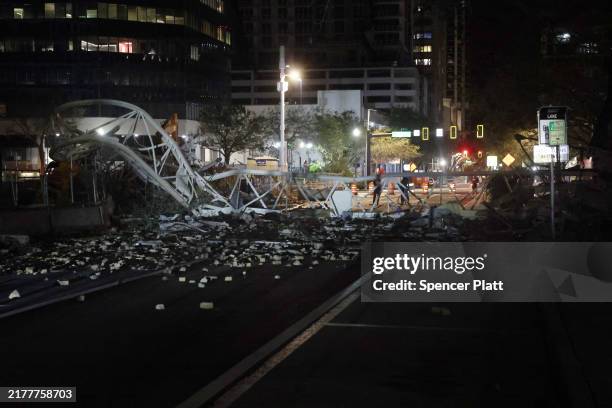 Crane sits on the street after crashing down into the building housing the Tampa Bay Times offices after the arrival of Hurricane Milton on October...