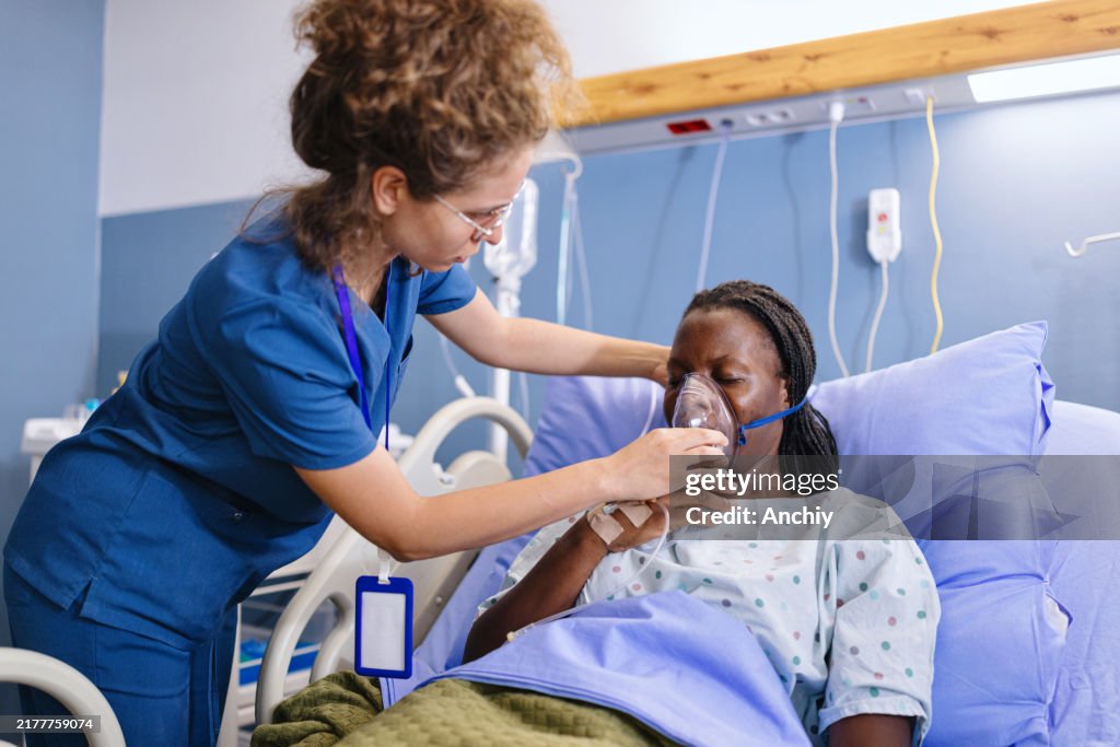 Close-up of a female nurse helping a woman with breathing problems