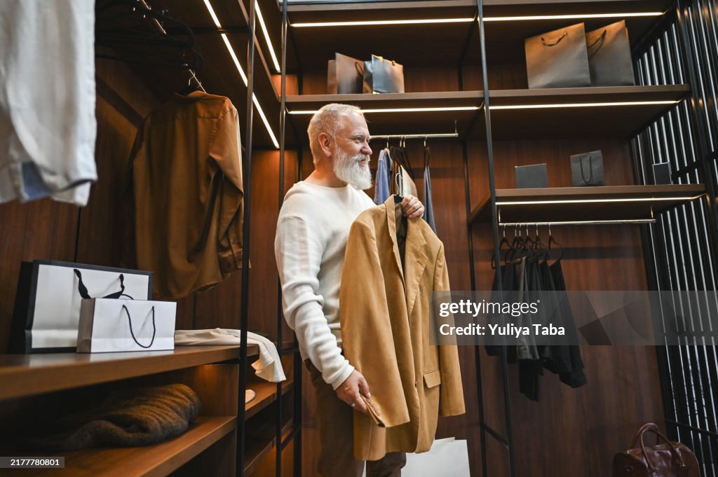 Senior man buying clothes at department store.