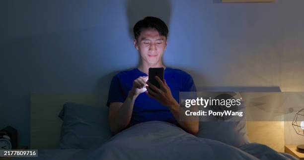man scroll smartphone dark - tired eyes stock pictures, royalty-free photos & images