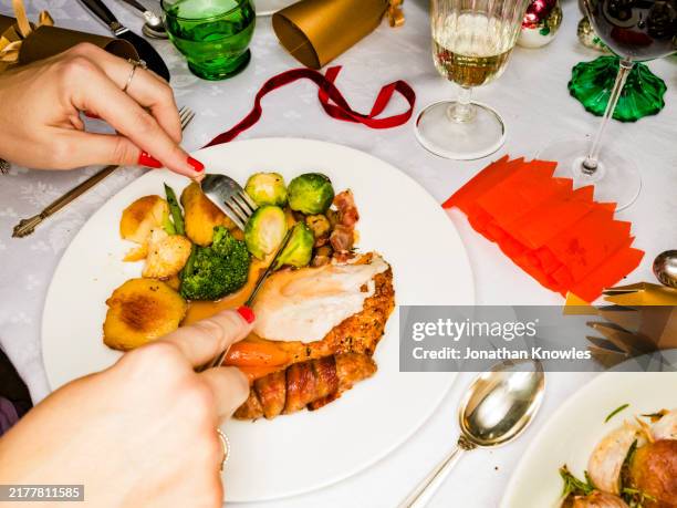 close up woman eating christmas dinner at table - plate stock pictures, royalty-free photos & images