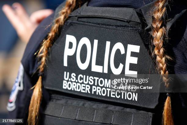 Customs and Border Protection officer talks with guests at the MCAS Miramar Airshow on September 28, 2024 in San Diego, California.