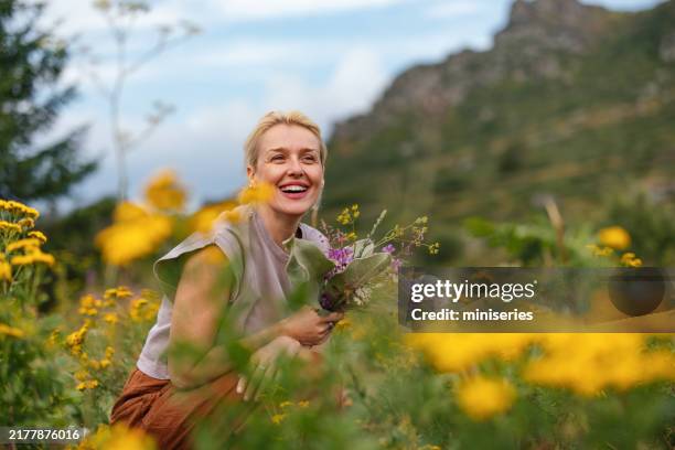 joyful woman enjoying nature in serene meadow setting - springtime stock pictures, royalty-free photos & images