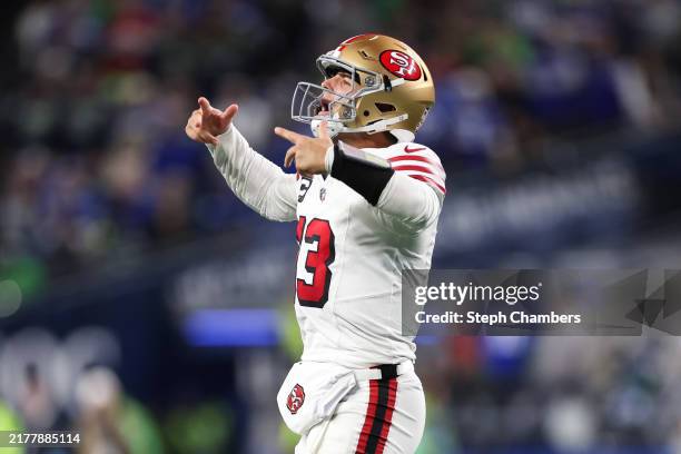 Brock Purdy of the San Francisco 49ers reacts after throwing a pass for a touchdown during the fourth quarter against the Seattle Seahawks at Lumen...