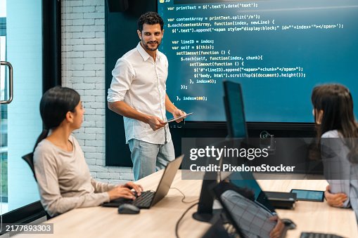 Software developer presenting the program coding language projection the large screen in meeting room. Software developer presenting the program coding language projection the large screen in meeting room.