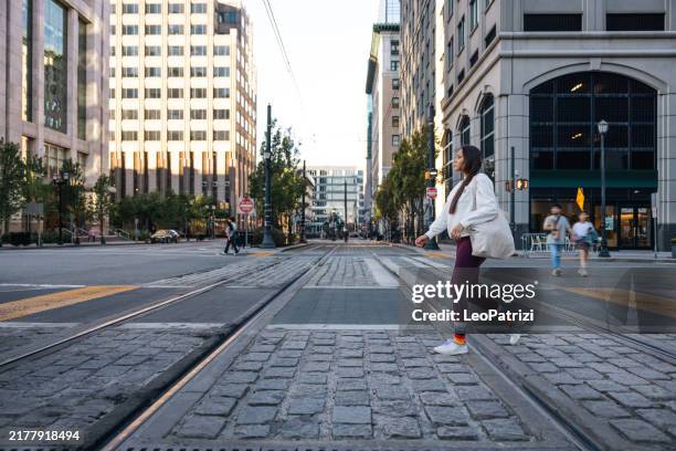 young woman with shopping bags crossing the street wearing rainbow socks - jersey city stock pictures, royalty-free photos & images