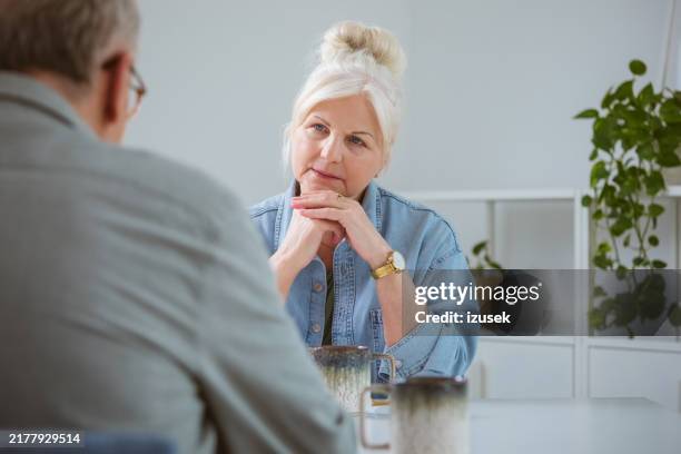 worried senior woman talking with her husband - looking stock pictures, royalty-free photos & images