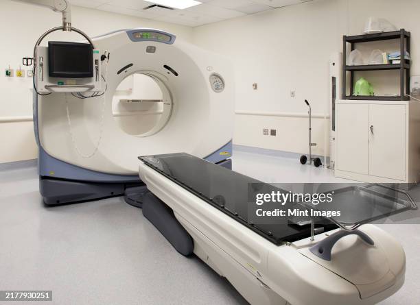a large mri magnetic resonance imaging scanner, with a patient bed - mri scanner stock pictures, royalty-free photos & images