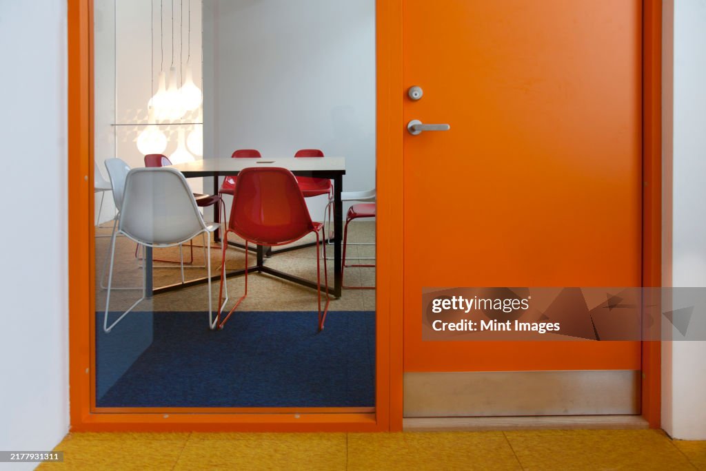 Modern meeting area in an office or college, a glass panel and view into a small room