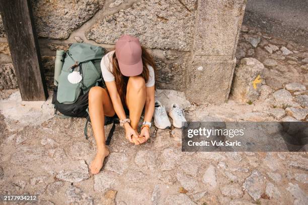 masaje de pies después de una larga caminata - ampolla lesión física fotografías e imágenes de stock