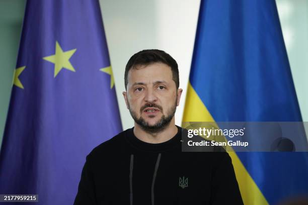 Ukrainian President Volodymyr Zelensky speaks to the media prior to talks with German Chancellor Olaf Scholz at the Chancellery on October 11, 2024...