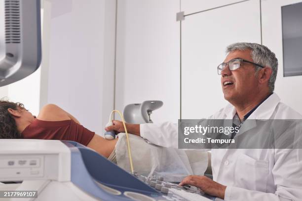 during the kidney check, the doctor is focused on the ultrasound of the young patient. - nephrology doctor stock pictures, royalty-free photos & images