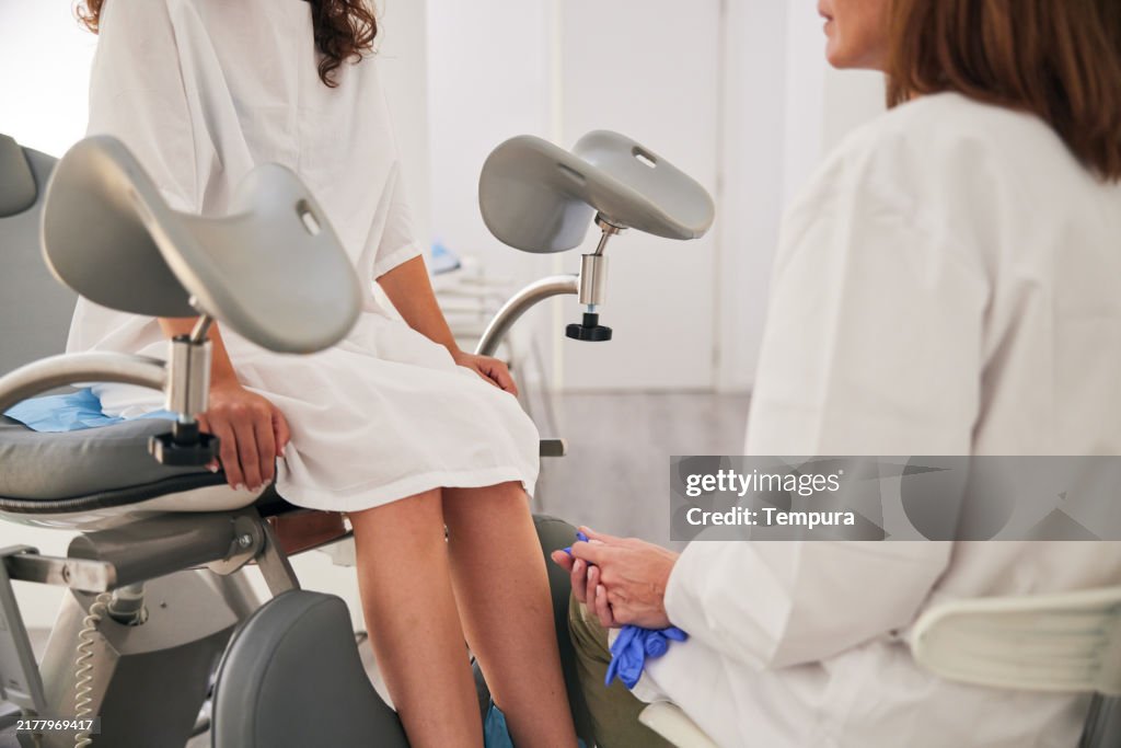 After completing the gynecological examination, the doctor and patient converse.