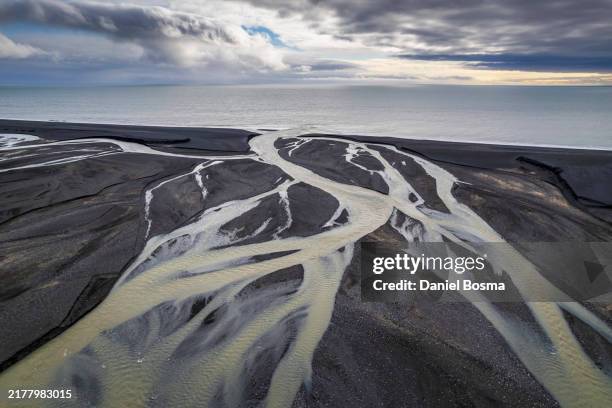 glacial river flowing into the atlantic ocean in southern iceland - ruisseau photos et images de collection