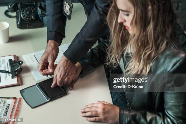 arrested woman - interrogation stock pictures, royalty-free photos & images