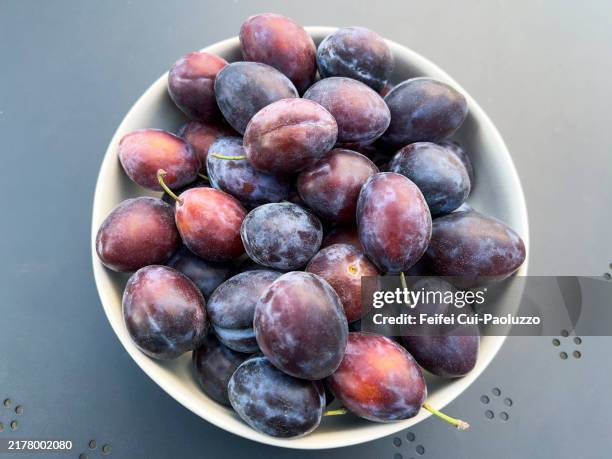 a bowl of prune plum in autumn - dried plum stock pictures, royalty-free photos & images