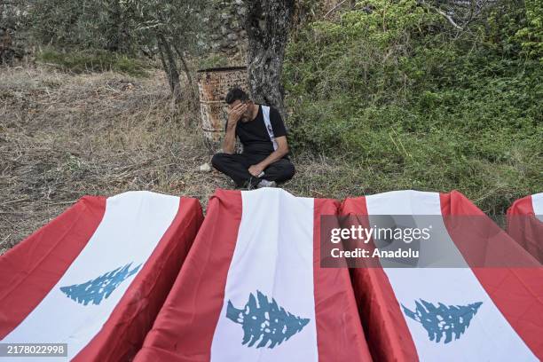 Relatives mourn during a funeral of 23 people, including 4 infants, women, and elderly, who lost their lives in an Israeli airstrike on the town of...
