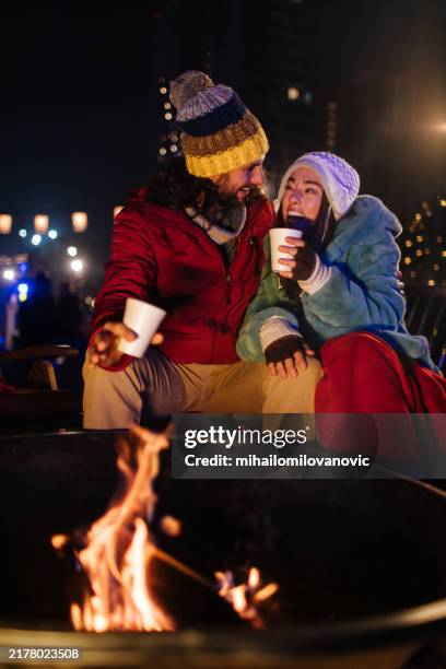 love next to a fire - haardvuur stockfoto's en -beelden