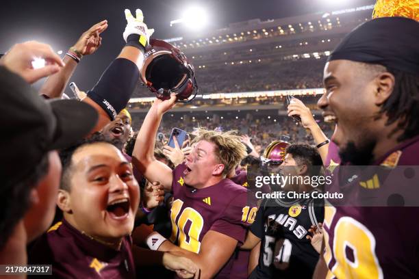 Quarterback Sam Leavitt of the Arizona State Sun Devils celebrates with fan after the Sun Devils defeated the Utah Utes 27-19 at Mountain America...