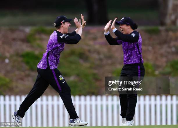 Elyse Villani of the Hobart Hurricanes celebrates with Lauren Smith of the Hobart Hurricanes after she took the catch to dismiss Ellie Johnston of...