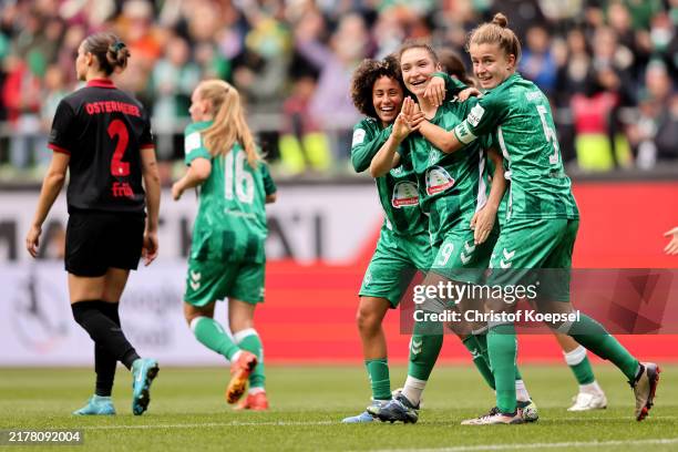Sophie Weidauer of Bremen celebrates the first goal with Amira Arfaoui and Michelle Ulbrich of Bremen during the Google Pixel Frauen Bundesliga match...