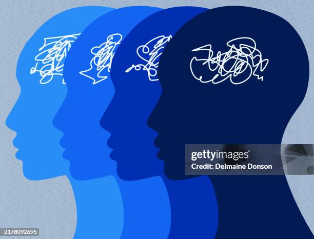 scribbled thoughts in multiple blue head silhouettes - attention deficit hyperactivity disorder stock illustrations