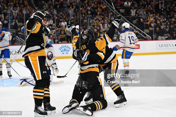 Evgeni Malkin of the Pittsburgh Penguins celebrates with teammates after scoring his 500th career goal in the third period during the game against...