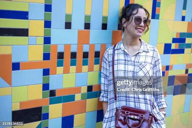 young adult filipino woman standing in front of vibrant colourful tiling background in bristol, england, europe - filipino fashion stock pictures, royalty-free photos & images