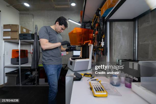 engineer working at a 3d printing lab making a model - plastic model kit stock pictures, royalty-free photos & images