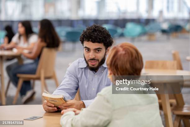 young man attends job training event in community space - job fair stock pictures, royalty-free photos & images