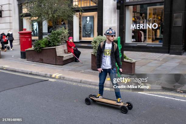 Man on an hand controlled electric skateboard on 9th October 2024 in London, United Kingdom.