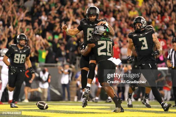 Dillon Gabriel of the Oregon Ducks celebrates a score with teammates during the second half against the Ohio State Buckeyes at Autzen Stadium on...