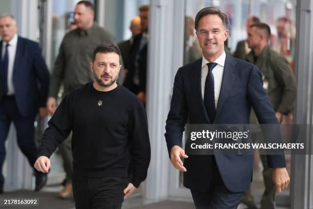 Secretary General Mark Rutte walks flanked by Ukraine's President Volodymyr Zelensky at the NATO headquarters in Brussels, on October 17, 2024.