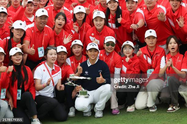 Ruoning Yin of China poses with course staff after winning the final round of the Buick LPGA Shanghai 2024 at Qizhong Garden Golf Club on October 13,...