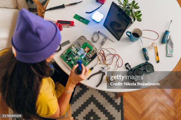 female engineer working at home - soldering electronics stock pictures, royalty-free photos & images