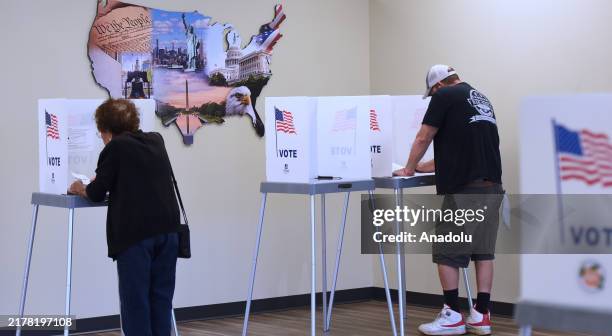 People fill out vote-by-mail ballots at the Orange County Supervisor of Elections office on October 17, 2024 in Orlando, Florida. About 2.4 million...