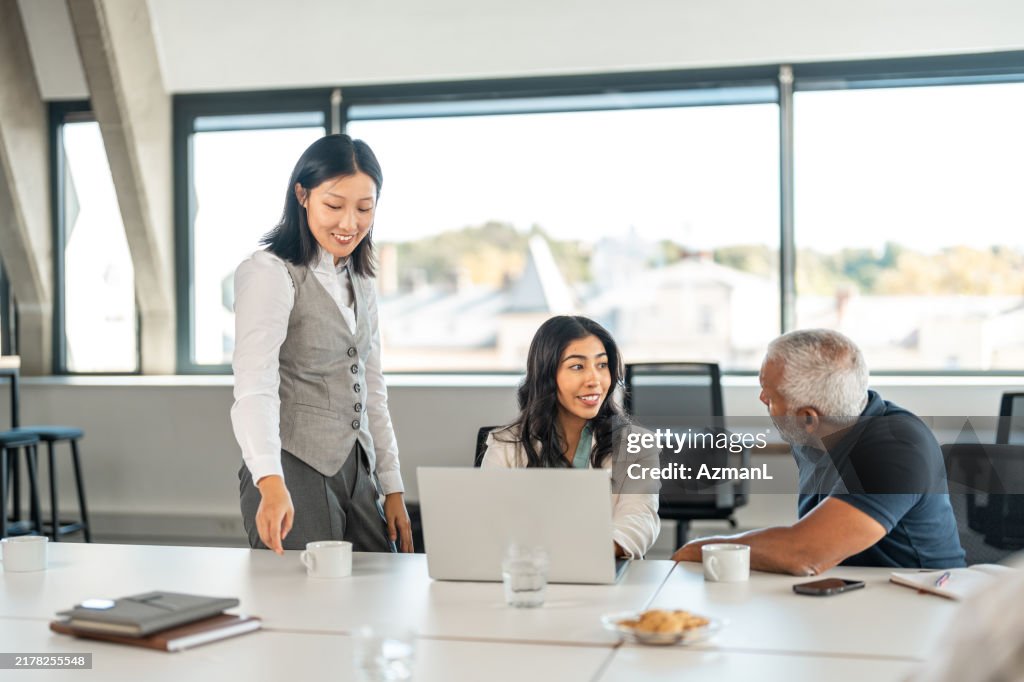 Diverse Team of Business Professionals Engages in Office Meeting