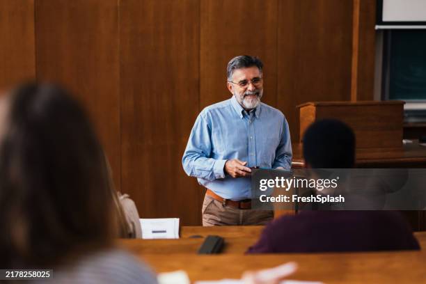 professor engaging with students in lecture hall setting - professor bildbanksfoton och bilder