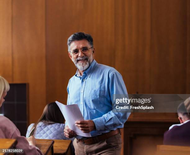 smiling professor engages students in university classroom - professor da faculdade imagens e fotografias de stock