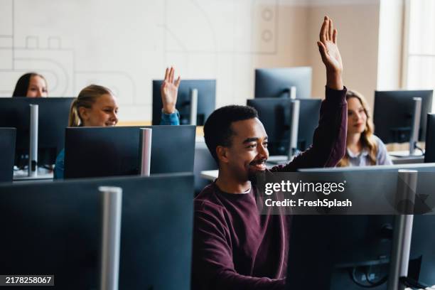 diverse students engaged in computer class discussion - college students computer lab stock pictures, royalty-free photos & images