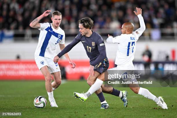 Jack Grealish of England battles for possession with Fredrik Jensen and Nikolai Alho of Finland during the UEFA Nations League 2024/25 League B Group...