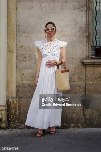 Maria Rosaria Rizzo wears white Huma Eyewear sunglasses, a white Chloe dress with lade details, brown leather Michael Kors open toes high heels, a...