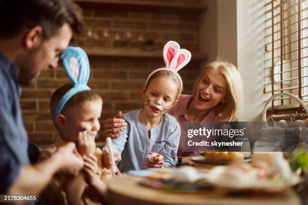 carefree family enjoying during easter in dining room. - easter breakfast stock pictures, royalty-free photos & images